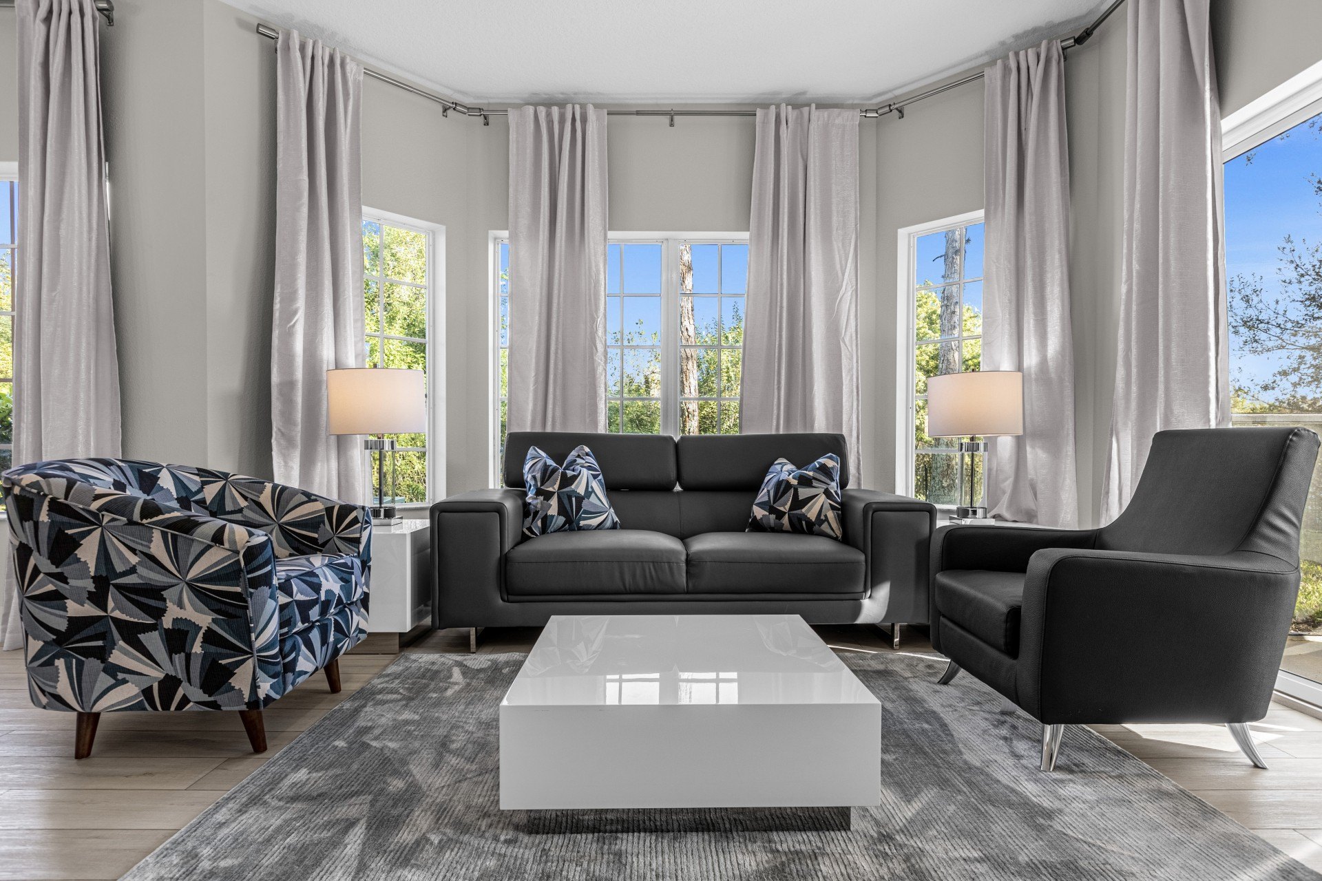 Renovated Estate Suite living room with sofa, armchairs and floor-to-ceiling windows