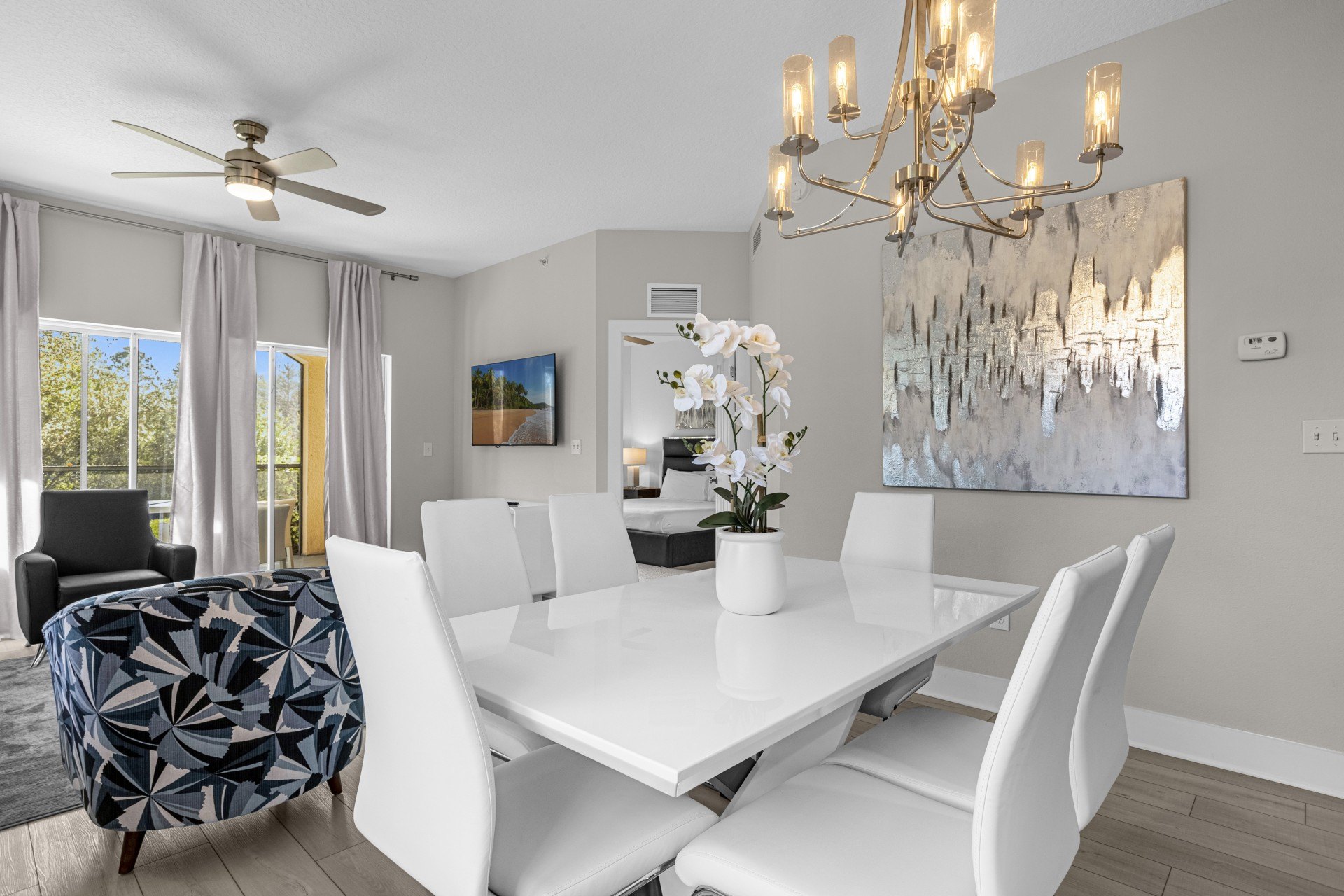 Estate Suite dining area with a white table, chandelier and seating for six
