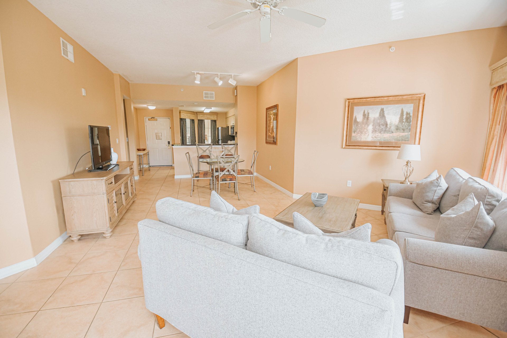 Deluxe Suite living room with sofas opening onto the dining area